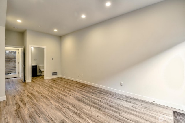 unfurnished living room with visible vents, recessed lighting, light wood-type flooring, and baseboards