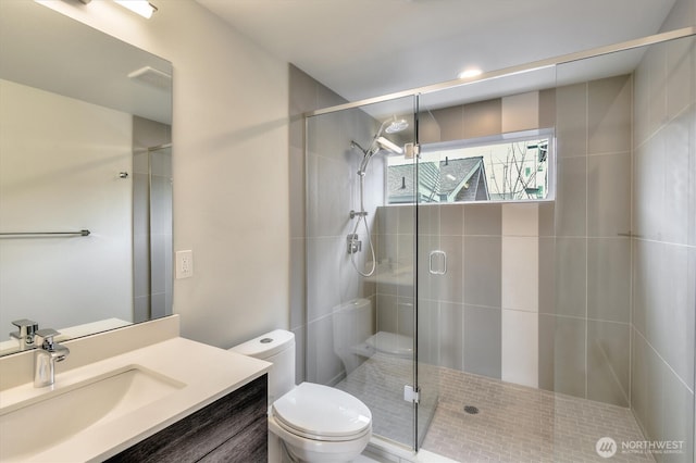 bathroom featuring visible vents, toilet, and a shower stall