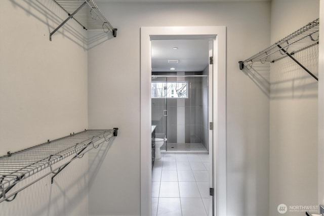 spacious closet featuring light tile patterned floors