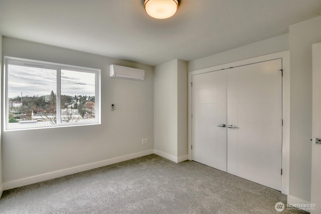 unfurnished bedroom featuring a closet, baseboards, carpet flooring, and a wall unit AC