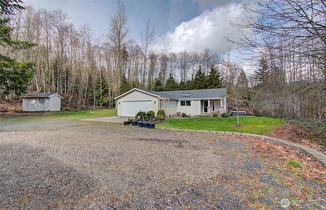 view of front of house featuring a front lawn, concrete driveway, an outdoor structure, a garage, and a storage shed