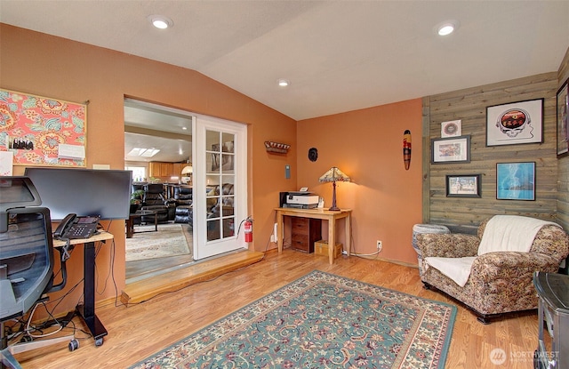 office featuring wood finished floors, recessed lighting, french doors, wood walls, and lofted ceiling