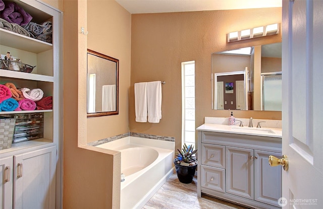 full bath with vanity, a bath, and an enclosed shower