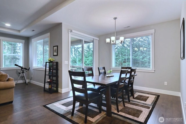 dining area featuring dark wood finished floors, a notable chandelier, recessed lighting, and baseboards