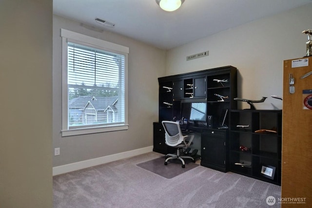 carpeted office with visible vents and baseboards