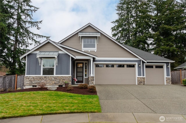 craftsman inspired home with a front lawn, stone siding, fence, board and batten siding, and concrete driveway