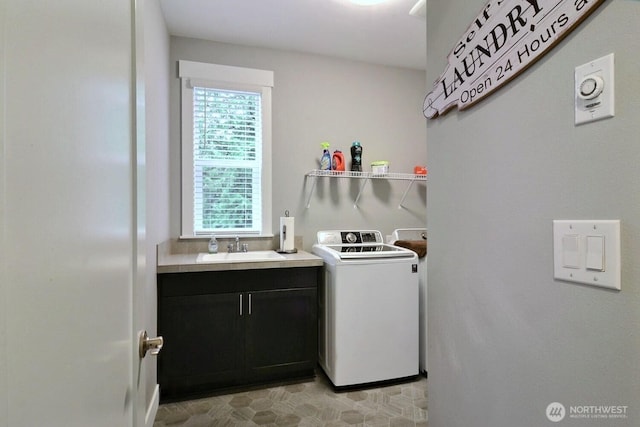 laundry area with washing machine and clothes dryer and a sink