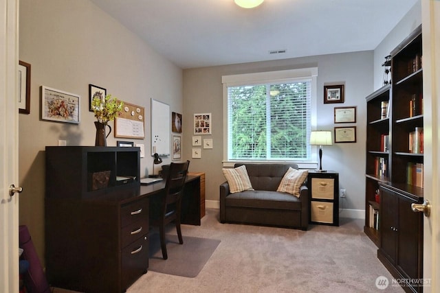 office area featuring visible vents, baseboards, and light colored carpet