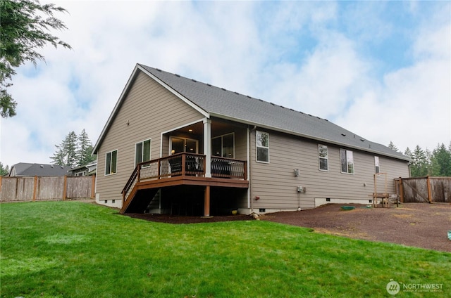 back of property with crawl space, a deck, a lawn, and a fenced backyard