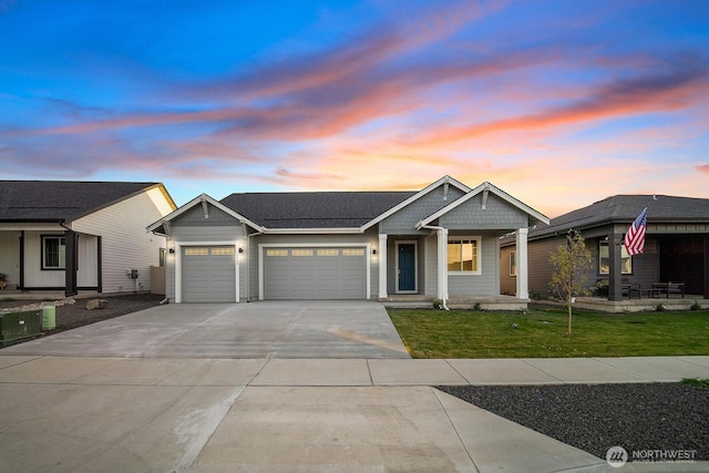 view of front of property with a garage, a front lawn, and driveway