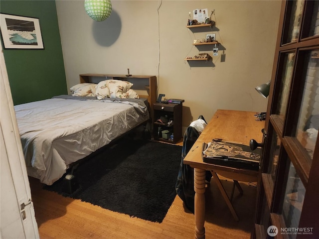 bedroom with wood finished floors