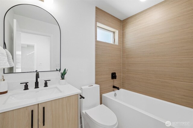 bathroom featuring vanity, shower / bathing tub combination, and toilet