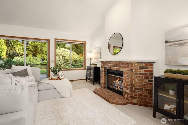 living room with a brick fireplace, carpet, baseboards, and high vaulted ceiling