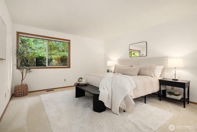 carpeted bedroom featuring visible vents and baseboards