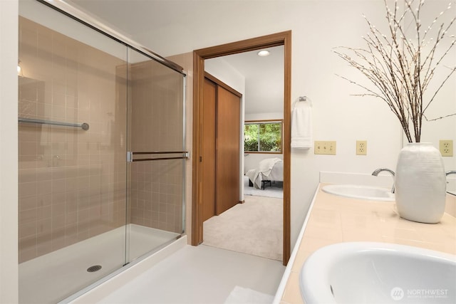 ensuite bathroom with a shower stall, connected bathroom, and a sink