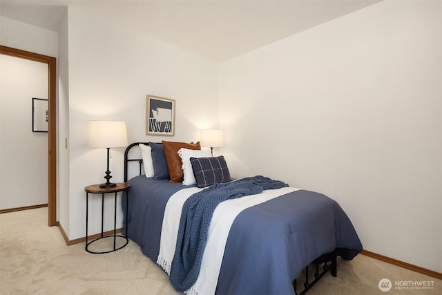 bedroom featuring baseboards and light carpet