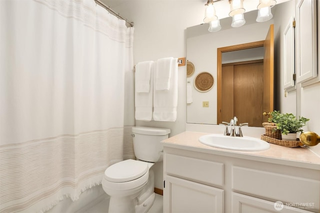 bathroom with a shower with shower curtain, toilet, and vanity