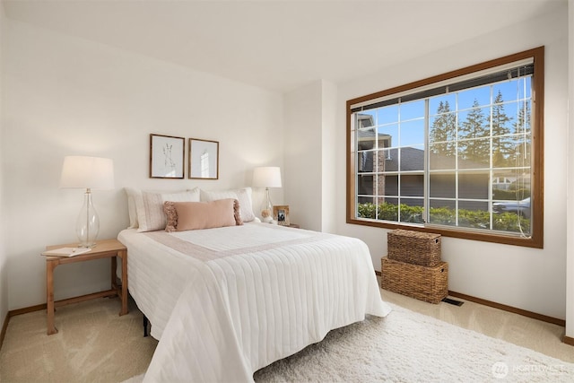 bedroom with baseboards and carpet