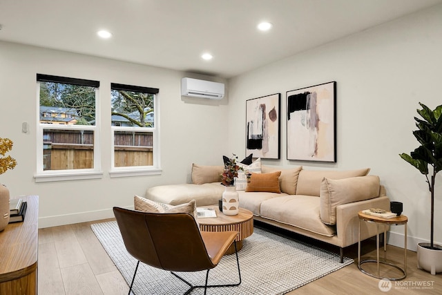 living room with a wall mounted air conditioner, baseboards, light wood-style flooring, and recessed lighting