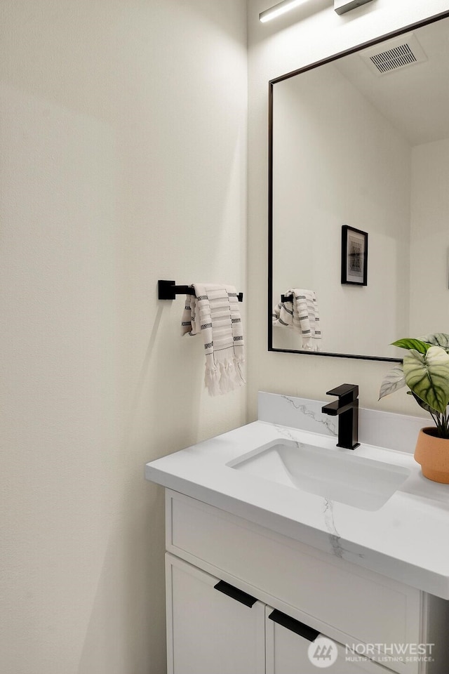 bathroom featuring vanity and visible vents