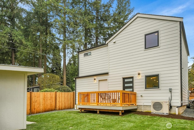 rear view of property with a lawn, a wooden deck, fence, and ac unit