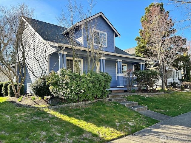 view of front of home with a porch and a front yard