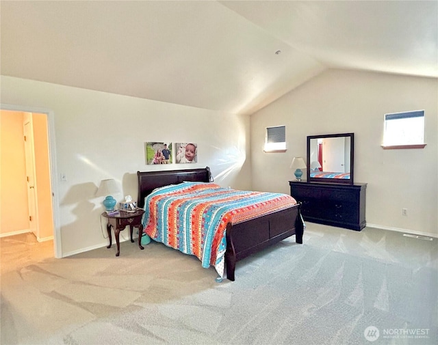 carpeted bedroom with lofted ceiling and baseboards