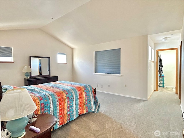 carpeted bedroom with baseboards and lofted ceiling