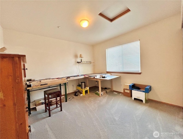 carpeted office featuring baseboards and attic access