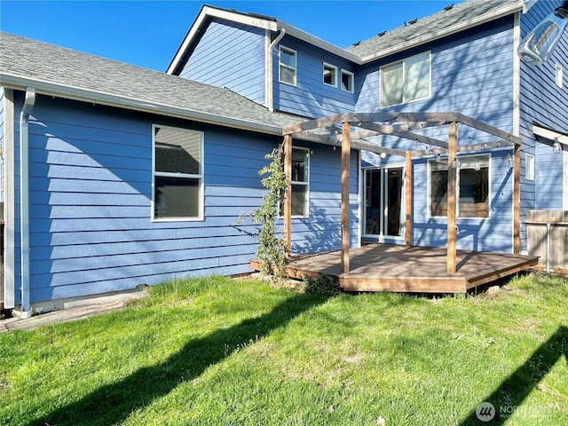 back of house with a wooden deck, a lawn, a pergola, and a shingled roof