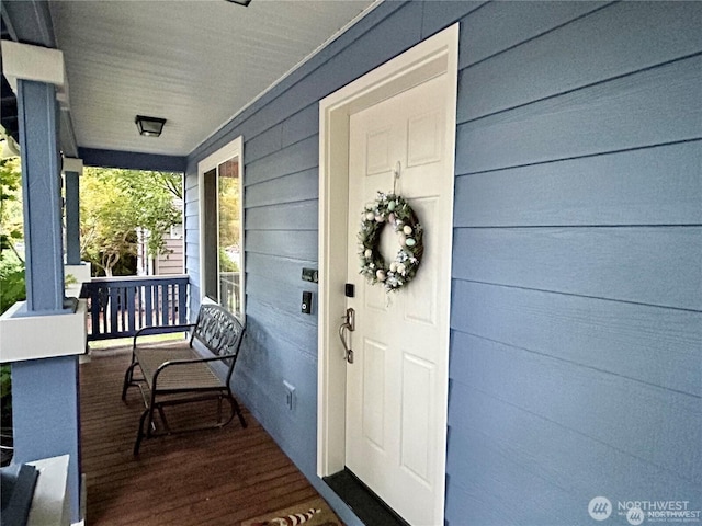 view of exterior entry with a porch