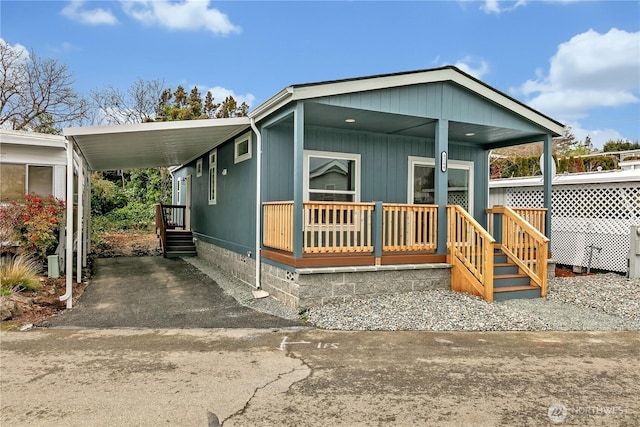 manufactured / mobile home with a carport, covered porch, and crawl space