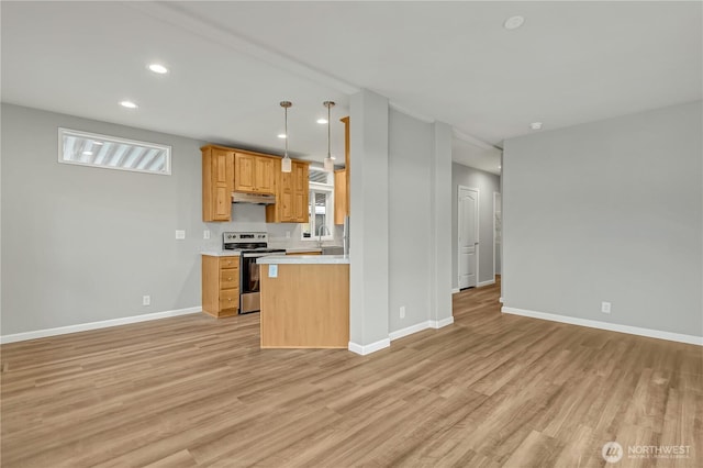 kitchen with light wood-style flooring, a sink, open floor plan, stainless steel electric range, and light countertops