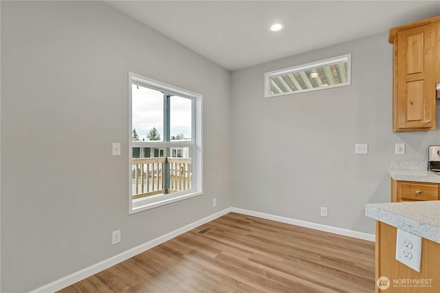 unfurnished dining area featuring recessed lighting, light wood-style floors, and baseboards