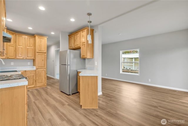 kitchen with baseboards, recessed lighting, freestanding refrigerator, light countertops, and light wood-type flooring