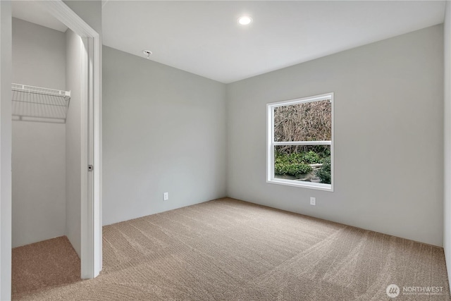 unfurnished bedroom with a closet, carpet flooring, and recessed lighting