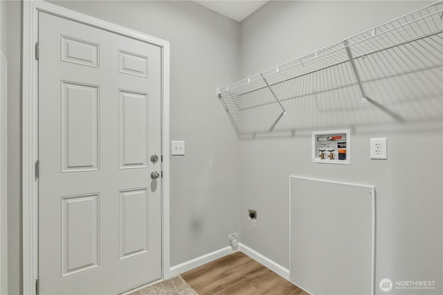 clothes washing area featuring washer hookup, wood finished floors, baseboards, hookup for an electric dryer, and laundry area