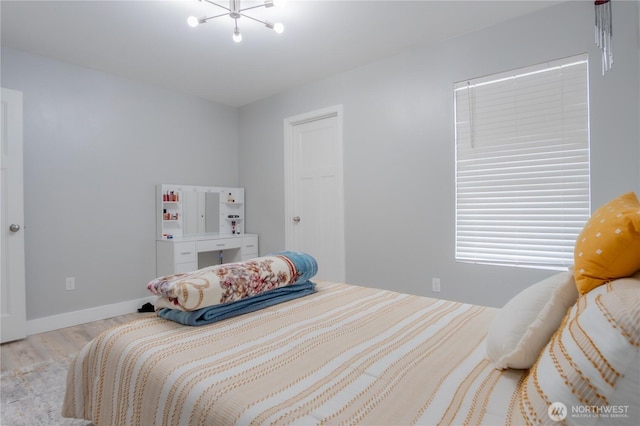 bedroom featuring baseboards and wood finished floors