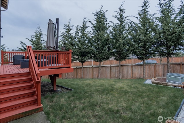 view of yard featuring stairway, a deck, and fence