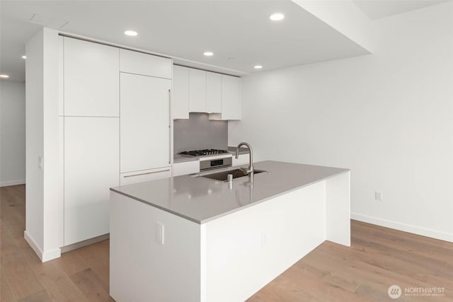 10232 NE 10th St Unit 1015, Bellevue, WA 98004 - kitchen featuring modern cabinets, light wood finished floors, white cabinets, recessed lighting, and a kitchen island with sink