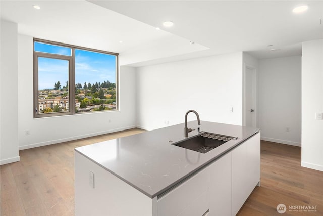 10232 NE 10th St Unit 1015, Bellevue, WA 98004 - kitchen with white cabinets, light wood-style flooring, a center island with sink, recessed lighting, and modern cabinets