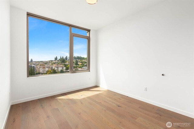 10232 NE 10th St Unit 1015, Bellevue, WA 98004 - unfurnished room with baseboards and wood finished floors