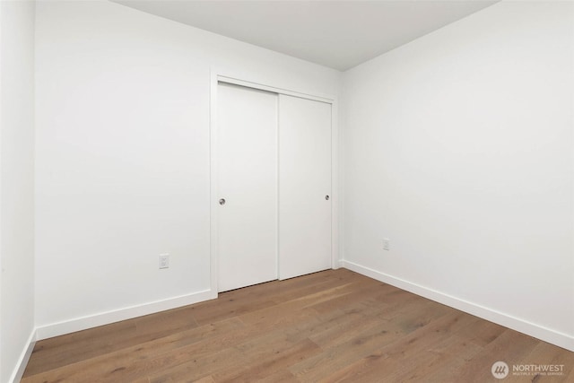 10232 NE 10th St Unit 1015, Bellevue, WA 98004 - unfurnished bedroom featuring wood finished floors and a closet