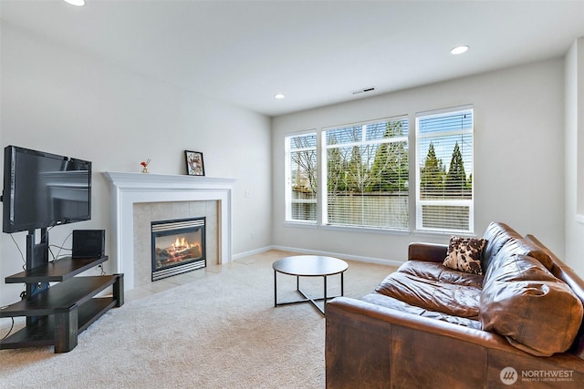 carpeted living area with recessed lighting, visible vents, baseboards, and a tiled fireplace