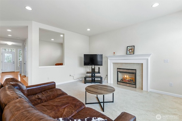 carpeted living room with recessed lighting, baseboards, and a tile fireplace