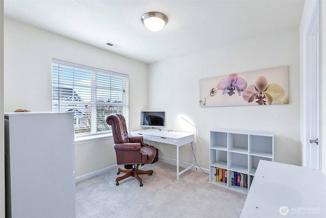 carpeted home office with visible vents and baseboards