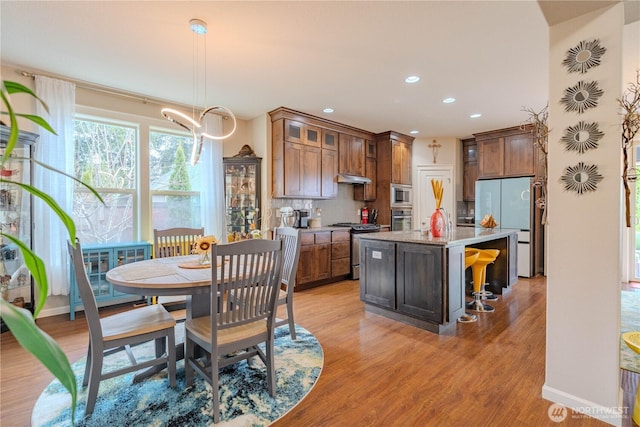 16103 NE 102nd Way, Vancouver, WA 98682 - kitchen featuring appliances with stainless steel finishes, decorative backsplash, a center island with sink, recessed lighting, and light wood-style floors