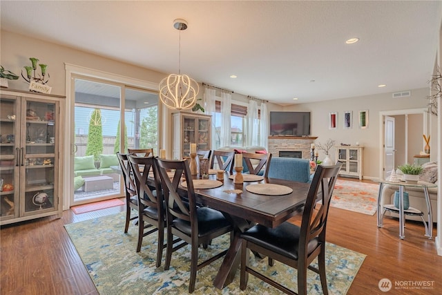 16103 NE 102nd Way, Vancouver, WA 98682 - dining room with a stone fireplace, wood finished floors, recessed lighting, and a chandelier