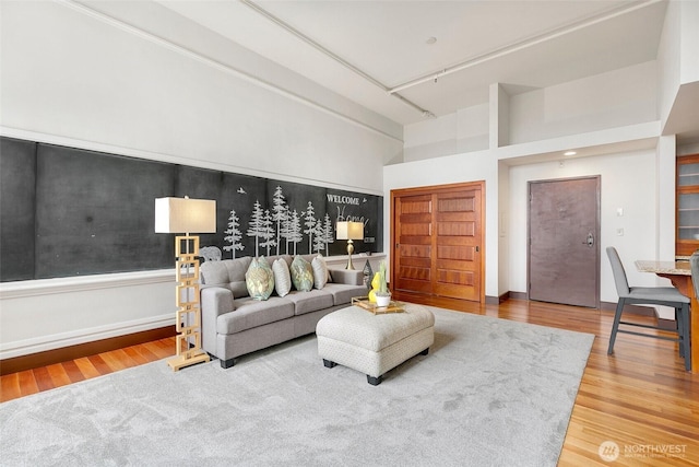 living area featuring a high ceiling and wood finished floors