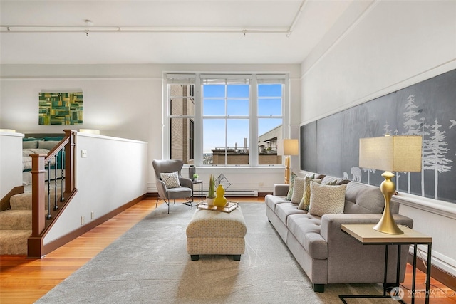 living area featuring wood finished floors and baseboards